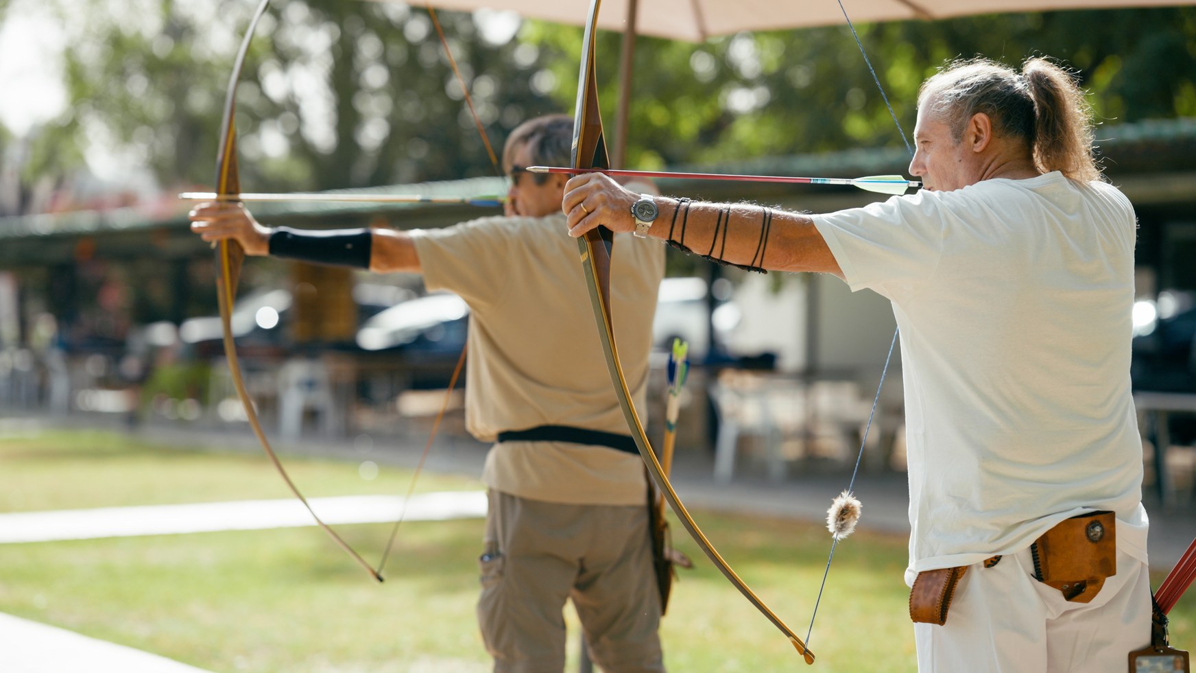 Beginner archer practicing shooting form at an archery range
